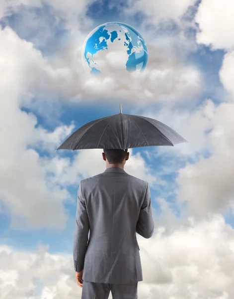 Businessman standing under umbrella — Stock Photo, Image