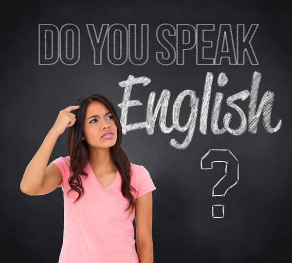 Brunette thinking against blackboard — Stock Photo, Image