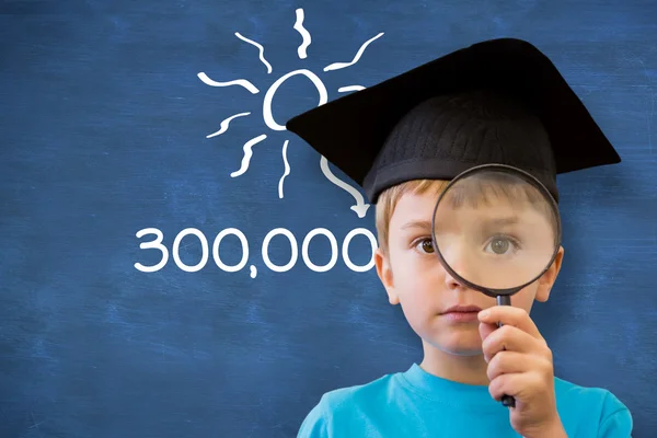 Pupil looking through magnifying glass — Stock Photo, Image