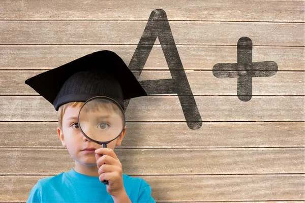 Pupil looking through magnifying glass — Stock Photo, Image