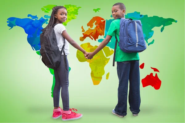 Pupils holding hands with world map — Stock Photo, Image