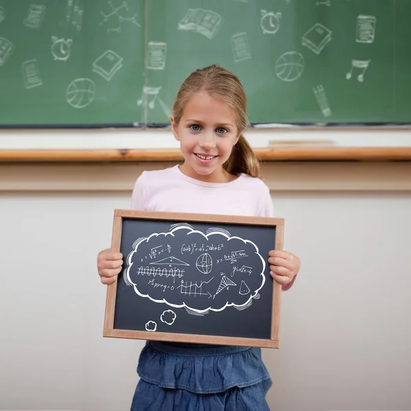 Cute pupil showing chalkboard — Stock Photo, Image