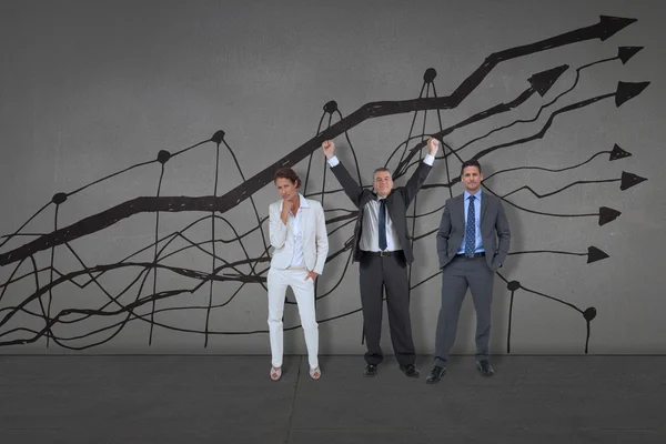 Business people against black wall — Stock Photo, Image