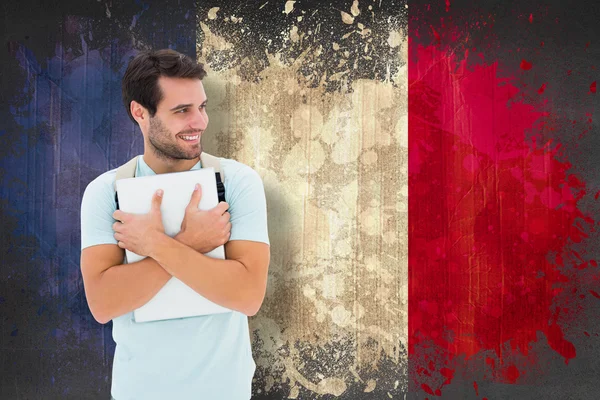 Estudante segurando laptop contra bandeira da frança — Fotografia de Stock