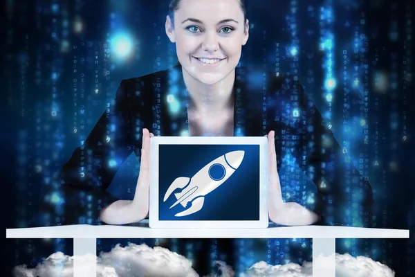 Businesswoman sitting at desk showing tablet — Stock Photo, Image