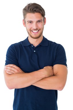 Handsome young man smiling with arms crossed clipart