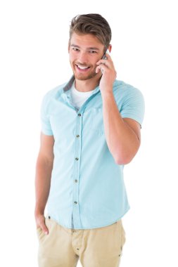 Handsome young man talking on his smartphone clipart