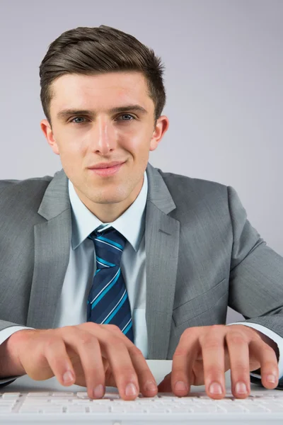 Homme d'affaires assis au bureau tapant — Photo