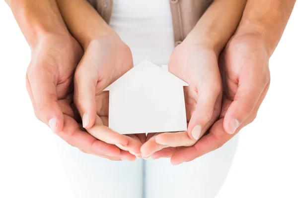 Couple holding miniature house in hands — Stock Photo, Image