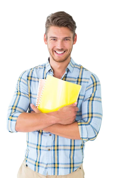 Guapo estudiante sosteniendo bloc de notas sonriendo a la cámara —  Fotos de Stock