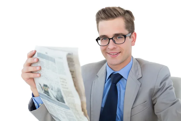 Nerdy businessman reading the newspaper — Stock Photo, Image