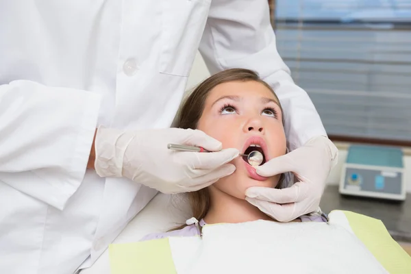 Dentista pediátrico examinando um dentes meninas — Fotografia de Stock