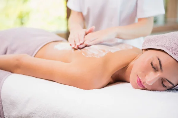 Attractive woman receiving back mask cream at spa center — Stock Photo, Image