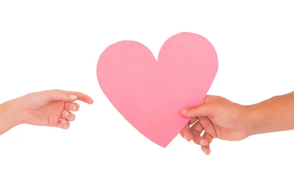 Couple passing a paper heart — Stock Photo, Image