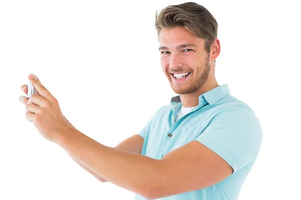 Handsome young man taking photo with smartphone — Stock Photo, Image