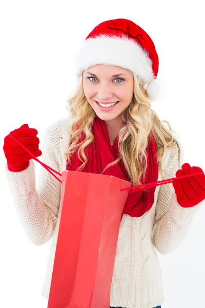 Festive blonde holding shopping bag — Stock Photo, Image