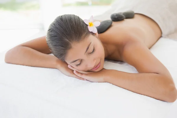 Brunette enjoying hot stone massage — Stock Photo, Image