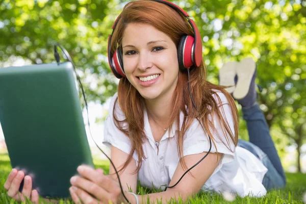 Redhead using her tablet pc — Stock Photo, Image