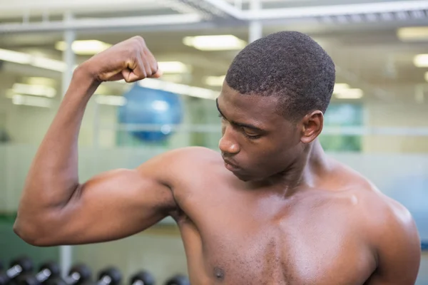 Homem muscular flexionando músculos no ginásio — Fotografia de Stock