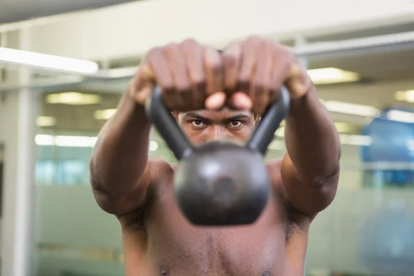 Shirtless man lifting kettle bell — Stock Photo, Image