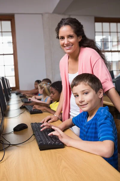 Pupils in computer class with teacher — Stock Photo, Image