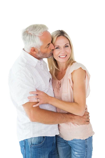 Affectionate man kissing his wife on the cheek — Stock Photo, Image