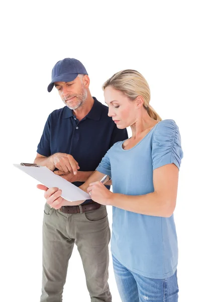 Happy blonde signing for a delivery — Stock Photo, Image