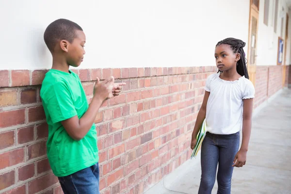 Pupil bullying another in the hall — Stock Photo, Image