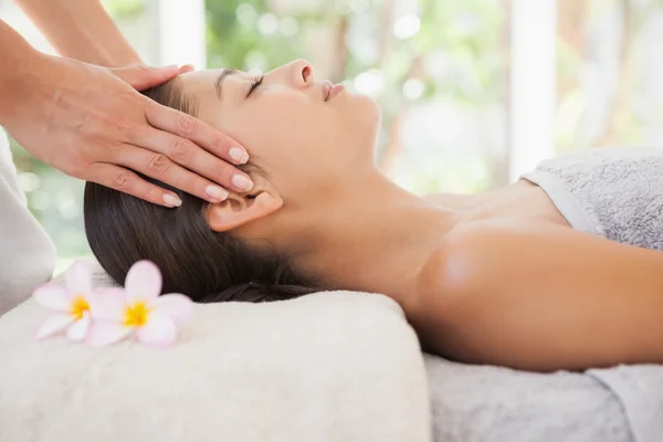 Beautiful brunette enjoying head massage — Stock Photo, Image