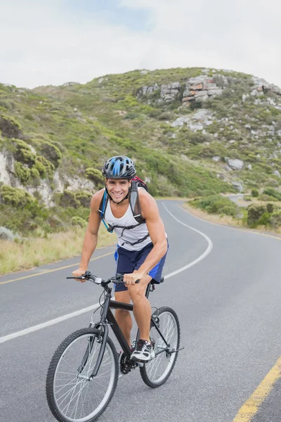 Athletic young man mountain biking — Stock Photo, Image