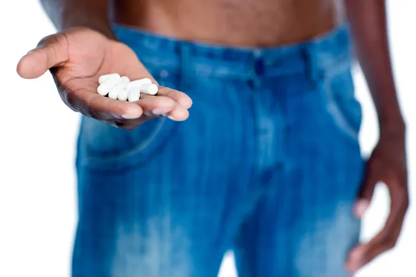 Man holding vitamin pills in hand — Stock Photo, Image