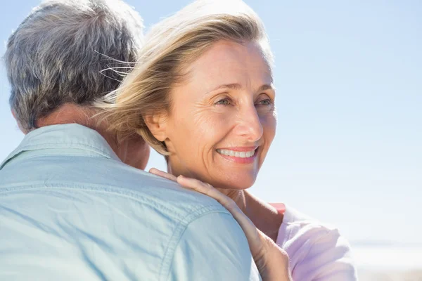 Senior woman hugging her partner — Stock Photo, Image