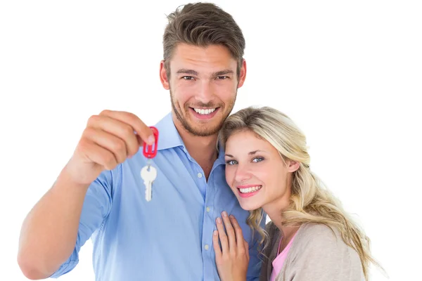 Attractive young couple showing new house key — Stock Photo, Image