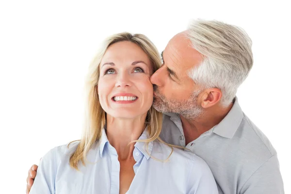 Affectionate man kissing his wife on the cheek — Stock Photo, Image