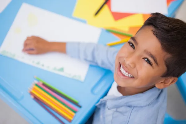 Cute little boy drawing at desk — Stock Photo, Image