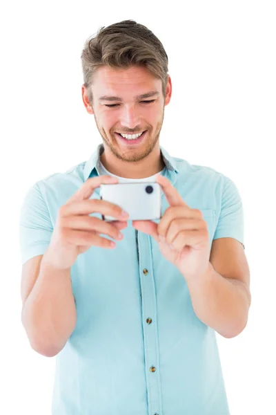 Handsome young man taking photo with smartphone — Stock Photo, Image