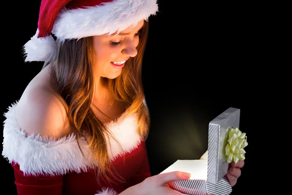 Brunette in santa outfit opening geschenk — Stockfoto