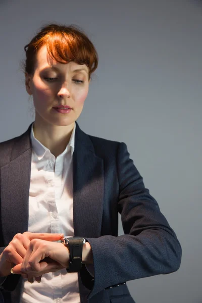 Mujer de negocios en traje comprobando la hora —  Fotos de Stock