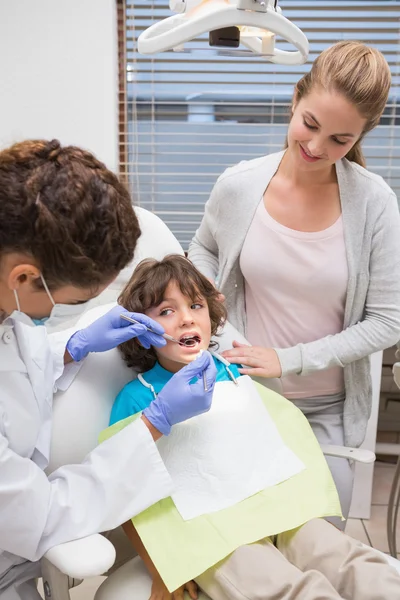 Odontólogo pediátrico examinando los dientes de un niño — Foto de Stock