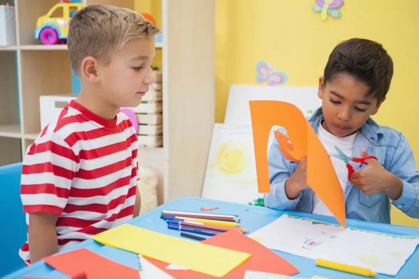 Little boys cutting paper shapes — Stock Photo, Image