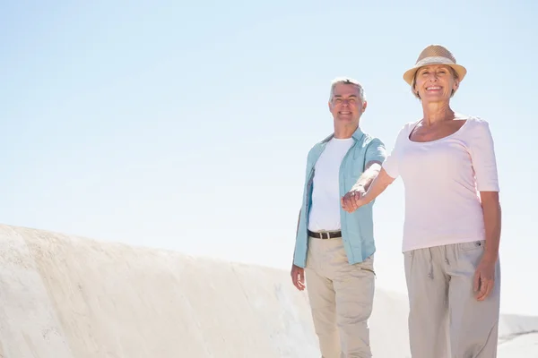 Happy senior couple walking on the pier — Stock Photo, Image