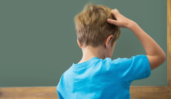 Thinking pupil scratching his head — Stock Photo, Image