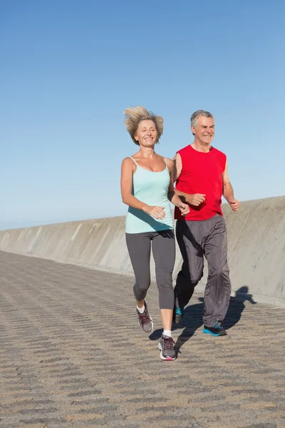 Active senior couple out for a jog — Stock Photo, Image