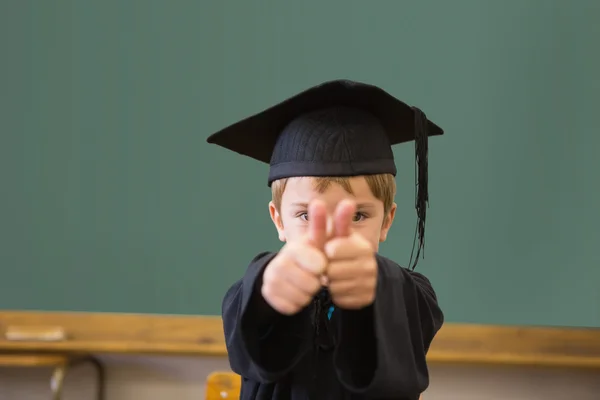 Pupil in graduation robe in classroom — Stock Photo, Image