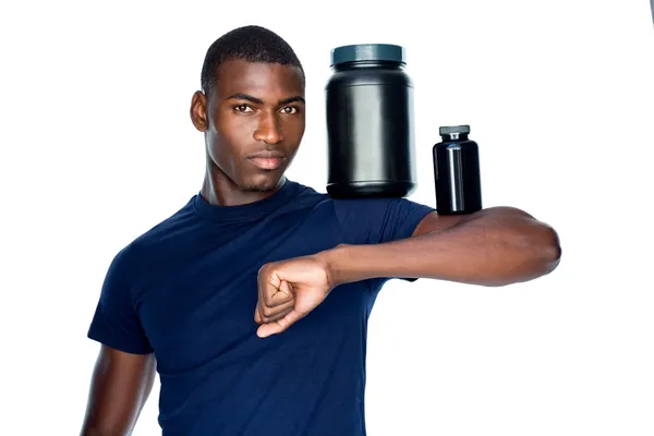 Man holding bottles with supplements — Stock Photo, Image