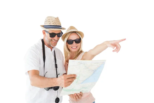 Feliz casal turista usando mapa e apontando — Fotografia de Stock