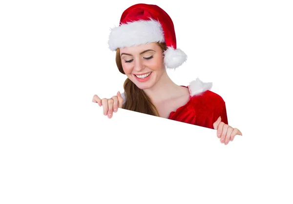 Pretty girl in santa costume showing card — Stock Photo, Image