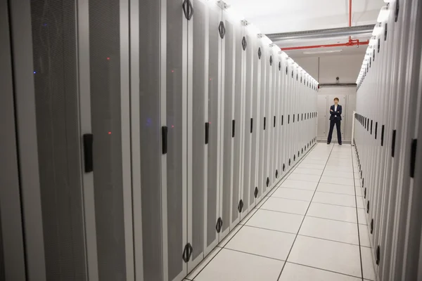 Serious technician standing in server hallway — Stock Photo, Image