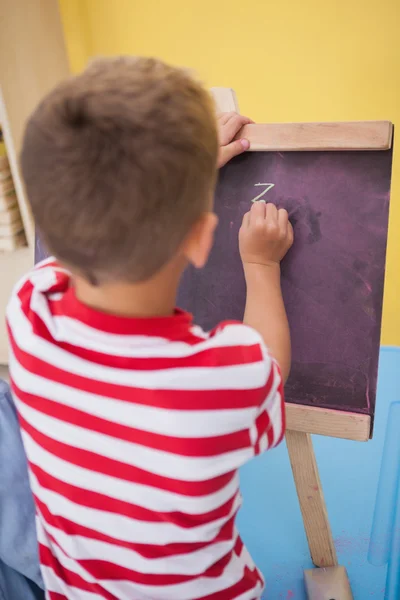 Little boy drawing on chalkboard — Stock Photo, Image