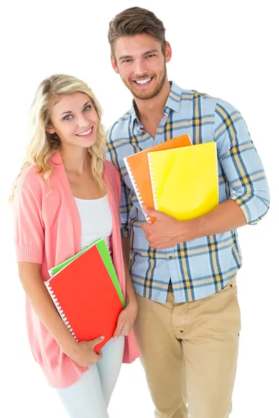 Attractive student couple smiling at camera — Stock Photo, Image